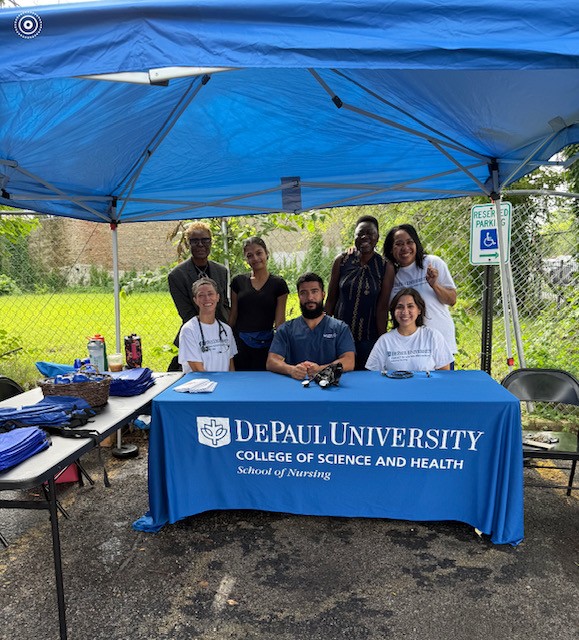 People at a booth labeled 'DePaul University, College of Science and Heath, School of Nursing' People at a booth labeled 'DePaul University, College of Science and Heath, School of Nursing'